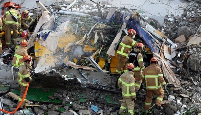 Nine people were killed when a bus fell on a five-storey building during demolition